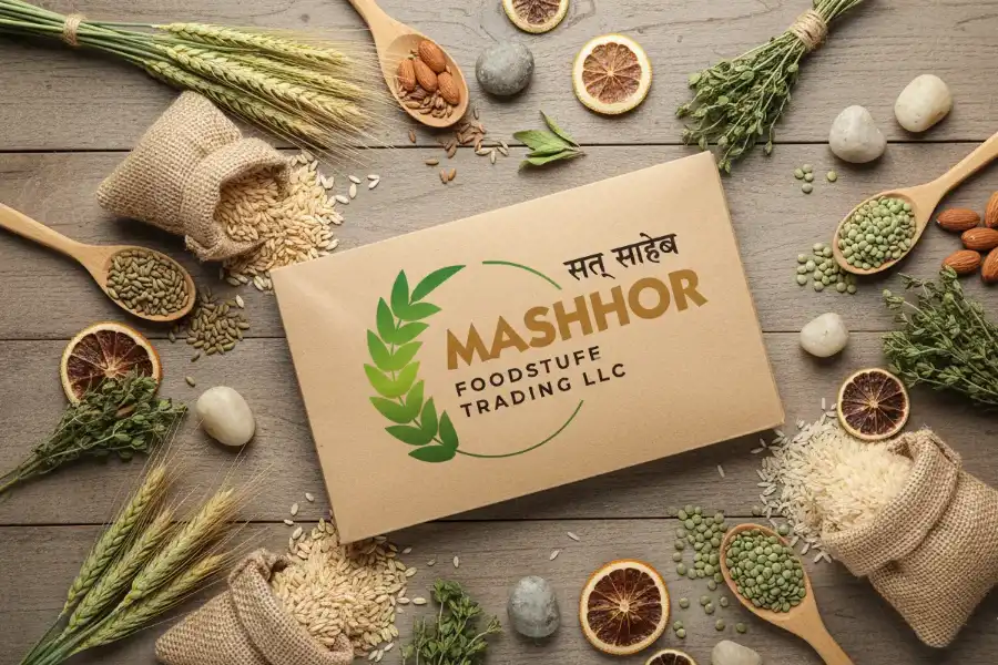 A Mashhor Foodstuff Trading box photographed from above on a wooden table, surrounded by grains, pulses, herbs and dried citrus.